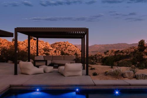 a gazebo with a table and chairs and a pool at Whistling Rock By The Cohost Company in Yucca Valley Service Center Heliport