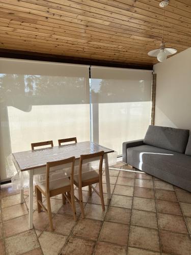 a table and chairs in a living room with a couch at Agriturismo Al Buttasella in Lavariano
