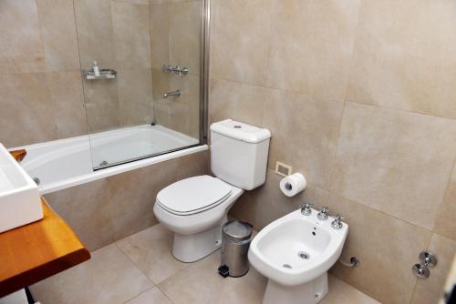 a bathroom with a toilet and a shower and a sink at Galileo Boutique Hotel in San Carlos de Bariloche