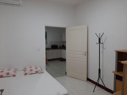 a bedroom with a white bed and a white closet at T3 à 1 minute de la barge - Petite terre in Dzaoudzi