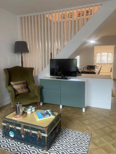 a living room with a tv and a coffee table at Seaside Retreat in Broadwater