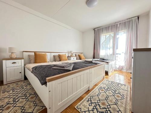 a bedroom with a large bed and a window at Sarajevo center in Sarajevo