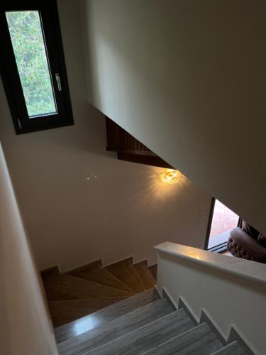 a stairway with a window in a house at Entire Apartment 140m2 near Syvota and Parga in Makrochóra