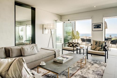 a living room with a couch and a table at Ocean Vue in Cape Town