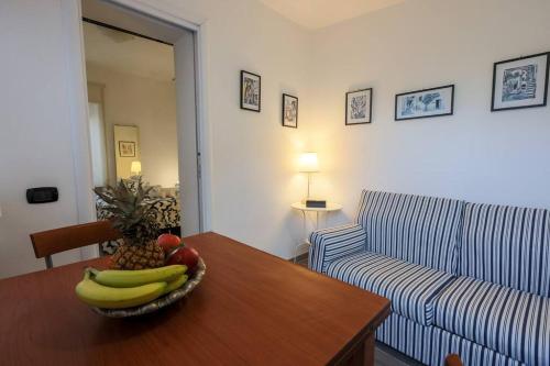 a living room with a bowl of fruit on a table at Attico Frascati La Cattedrale, soggiorno esclusivo nel centro storico in Frascati