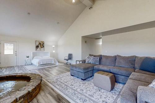 a large living room with a couch and a tub at North Forth Ranch in Gravette