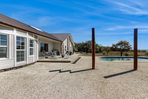 a house with a patio and a swimming pool at North Forth Ranch in Gravette