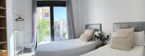 Ένα ή περισσότερα κρεβάτια σε δωμάτιο στο Casa con jardín, aparcamiento