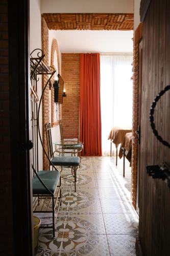 a living room with chairs and a large window at Janashia Hotels in Tbilisi City