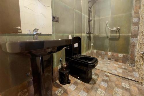 a bathroom with a sink and a toilet at Villa Mirasol Hotel in Tangier