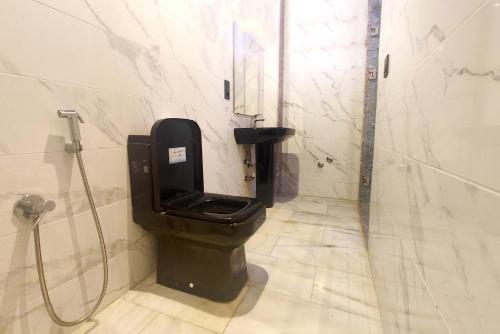 a bathroom with a black toilet and a shower at Villa Mirasol Hotel in Tangier