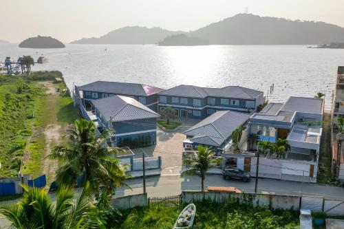 an aerial view of houses next to the water at VELINN Pousada Angra Sunset in Angra dos Reis