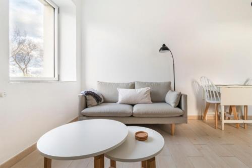 a living room with a couch and a table at Apartamento con vistas a la playa in Santander