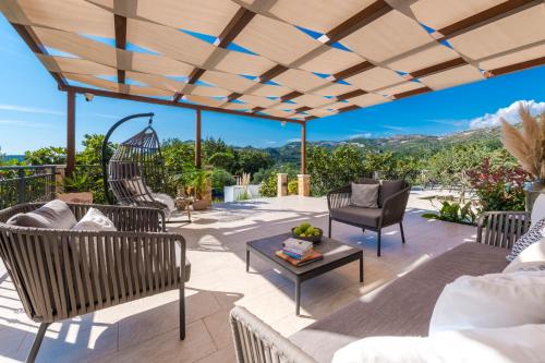 a patio with chairs and a table at Villa Paulina in Mlini