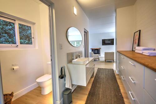 a bathroom with a sink and a toilet at White Penguin in Stilbaai