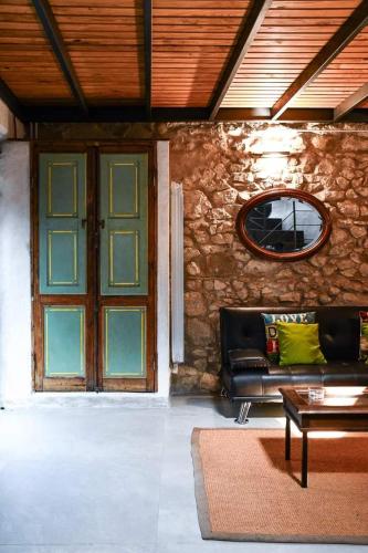 a living room with a couch and a window and a door at Rifugio sotto la torre 2 in Olevano Romano