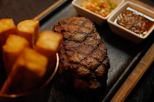 a piece of steak and some food on a tray at Palladio Hotel Buenos Aires - MGallery Collection in Buenos Aires