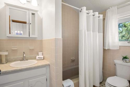 a bathroom with a toilet and a sink and a shower at Unique waterfront home with stunning views in Wellfleet