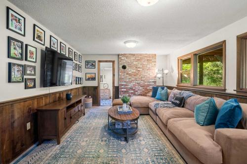 a living room with a couch and a tv at Unique waterfront home with stunning views in Wellfleet