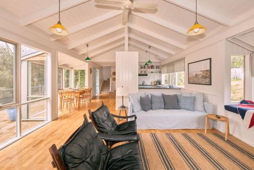 a living room with a couch and a table at The Hideaway in Aireys Inlet