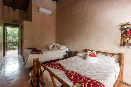 a bedroom with two beds in a room at Casa Playa Verde - 200Mbps Wifi in Troncones