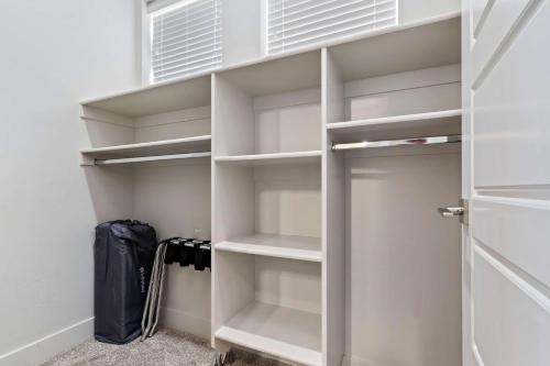 a walk in closet with white shelves and a door at 30-31| 2 Homes in St George with Private Pools and Hot Tubs in Santa Clara