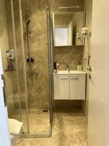a bathroom with a shower and a sink at Vacation home with private pool, Fethiye, Oludeniz in Cedit