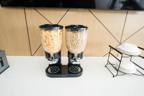 two black blenders filled with food sitting on a table at MainStay Suites Knoxville Airport in Alcoa
