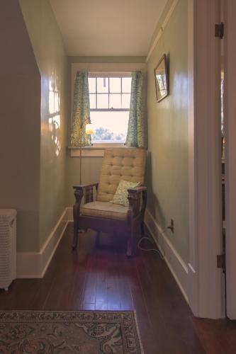 a hallway with a chair and a window at The Historic Benham-Johnston Bungalow in Sheridan