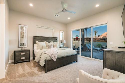 a bedroom with a bed and a balcony at 30-31| 2 Homes in St George with Private Pools and Hot Tubs in Santa Clara