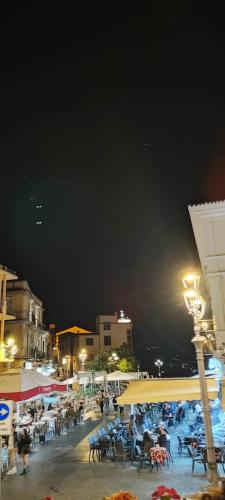 a group of people sitting on a patio at night at Palazzo Sardanelli in Pizzo