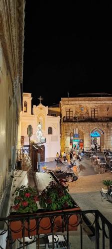 a view of a building with a courtyard at night at Palazzo Sardanelli in Pizzo