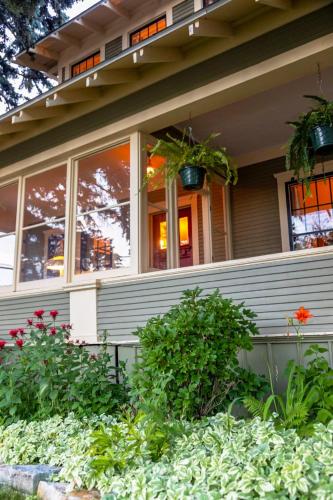 a house with windows and plants in front of it at The Historic Benham-Johnston Bungalow in Sheridan