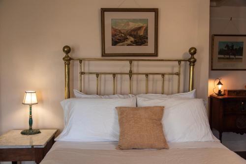 a bedroom with a large bed with white pillows at The Historic Benham-Johnston Bungalow in Sheridan