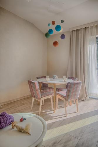 a dining room with a table and chairs and a room with a window at Kozia Chata in Brenna