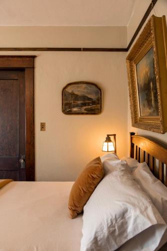 a bedroom with a bed with a pillow on it at The Historic Benham-Johnston Bungalow in Sheridan