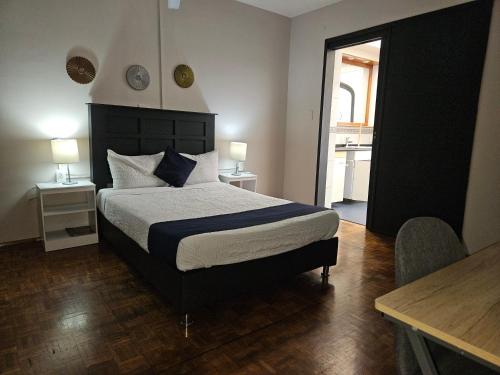 a bedroom with a bed and two tables and two lamps at Singular Coyoacán Pepper My Love! in Mexico City
