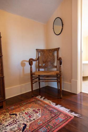 a chair in a room with a rug on the floor at The Historic Benham-Johnston Bungalow in Sheridan