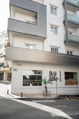 a white building with a store on the street at Kastro Hotel in Heraklio Town