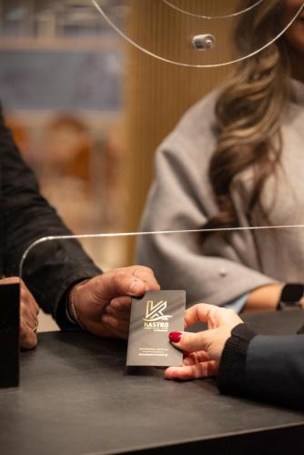 a couple of people sitting at a table with their hands at Kastro Hotel in Heraklio Town