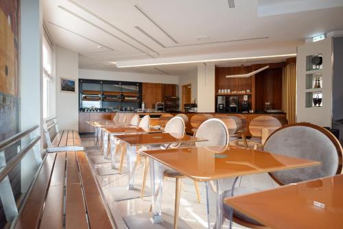 a row of tables and chairs in a restaurant at Kastro Hotel in Heraklio Town