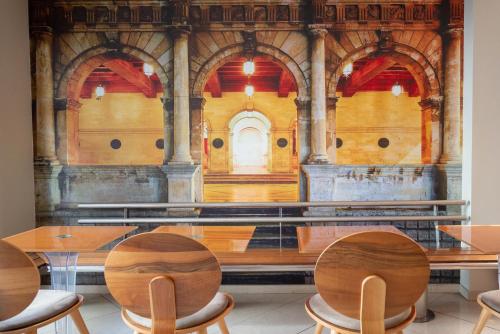 a table and chairs in a room with a building at Kastro Hotel in Heraklio Town