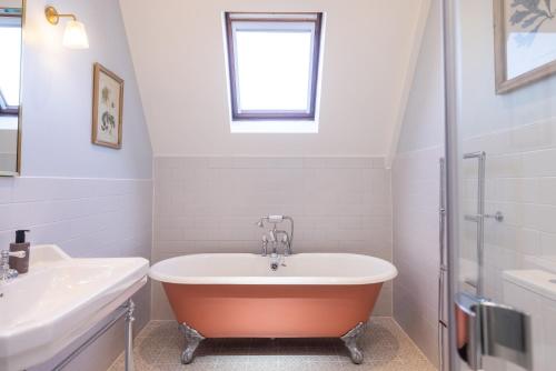 a bathroom with a bath tub and a sink at Best Western Plus The Connaught Hotel and Spa in Bournemouth
