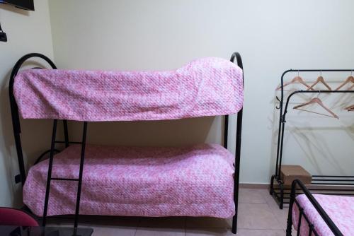a room with a pink blanket on a chair at B&B La Piazzetta in Boiano
