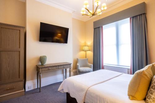a hotel room with a bed and a window at Best Western Plus The Connaught Hotel and Spa in Bournemouth
