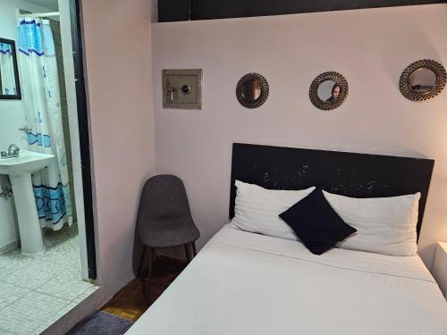 a bedroom with a bed and a sink and a mirror at Singular Coyoacán Pepper My Love! in Mexico City