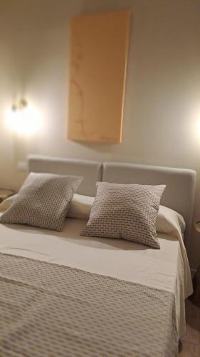 a bed with two pillows on top of it at Ta-49 bed e breakfast in Naples