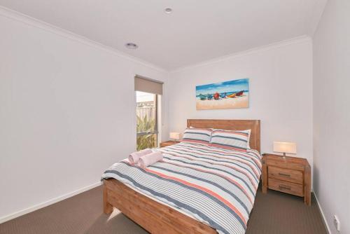 a bedroom with a bed and a window at Zeally Sands Pool Retreat in Torquay