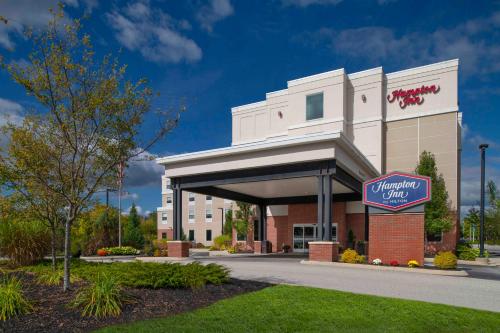 a building with a sign in front of it at Hampton Inn Lewiston-Auburn in Lewiston