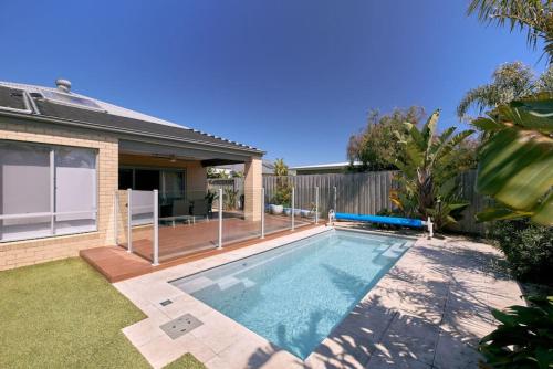 a swimming pool in the backyard of a house at Zeally Sands Pool Retreat in Torquay